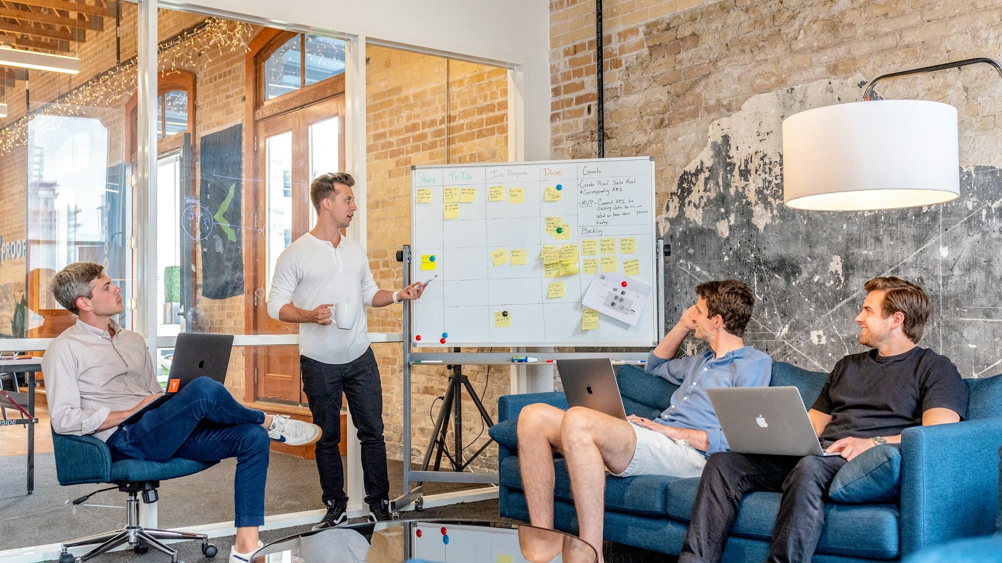 Colleagues reviewing a plan on a whiteboard together