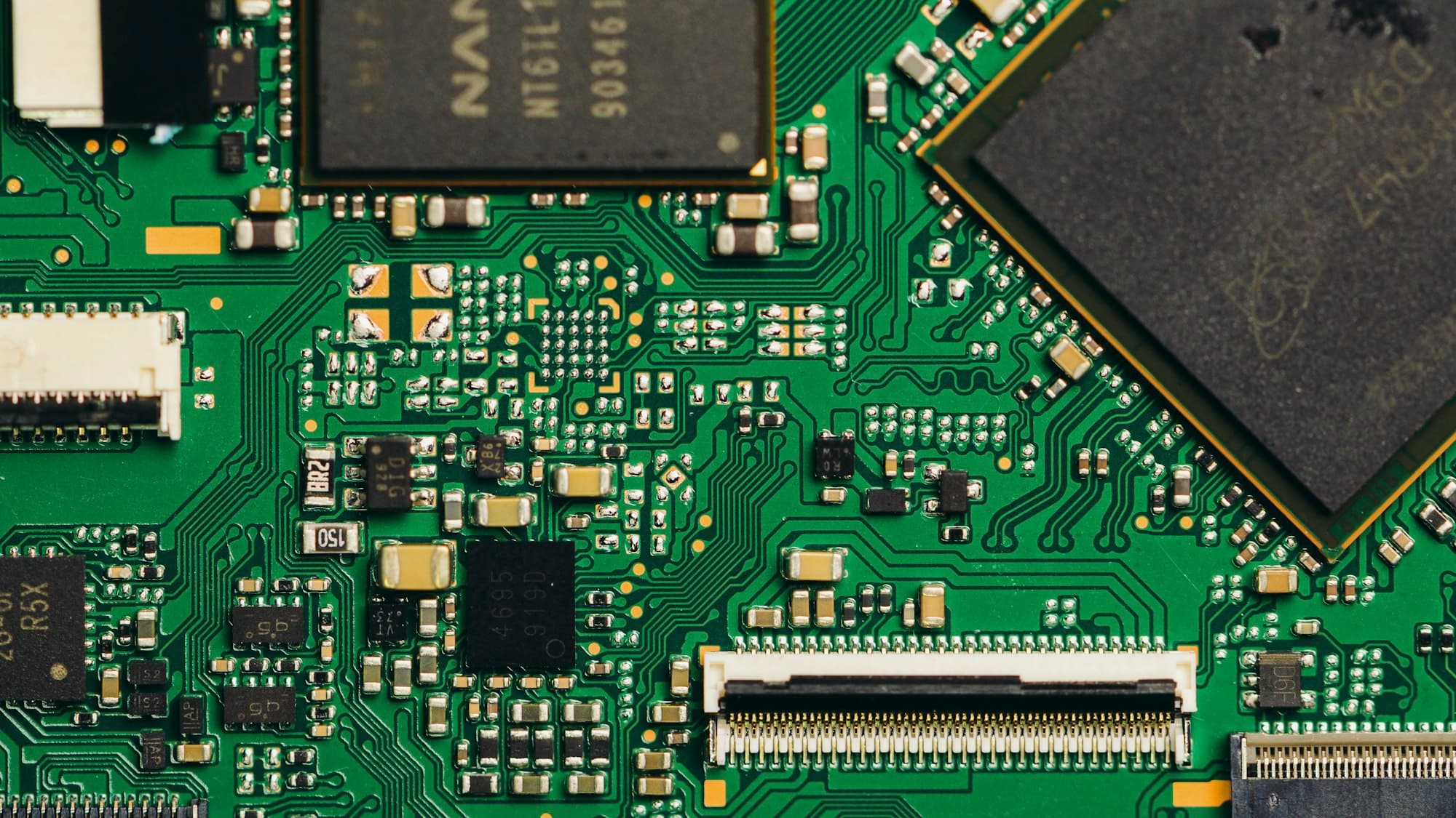 Close-up of a green circuit board with microchip components