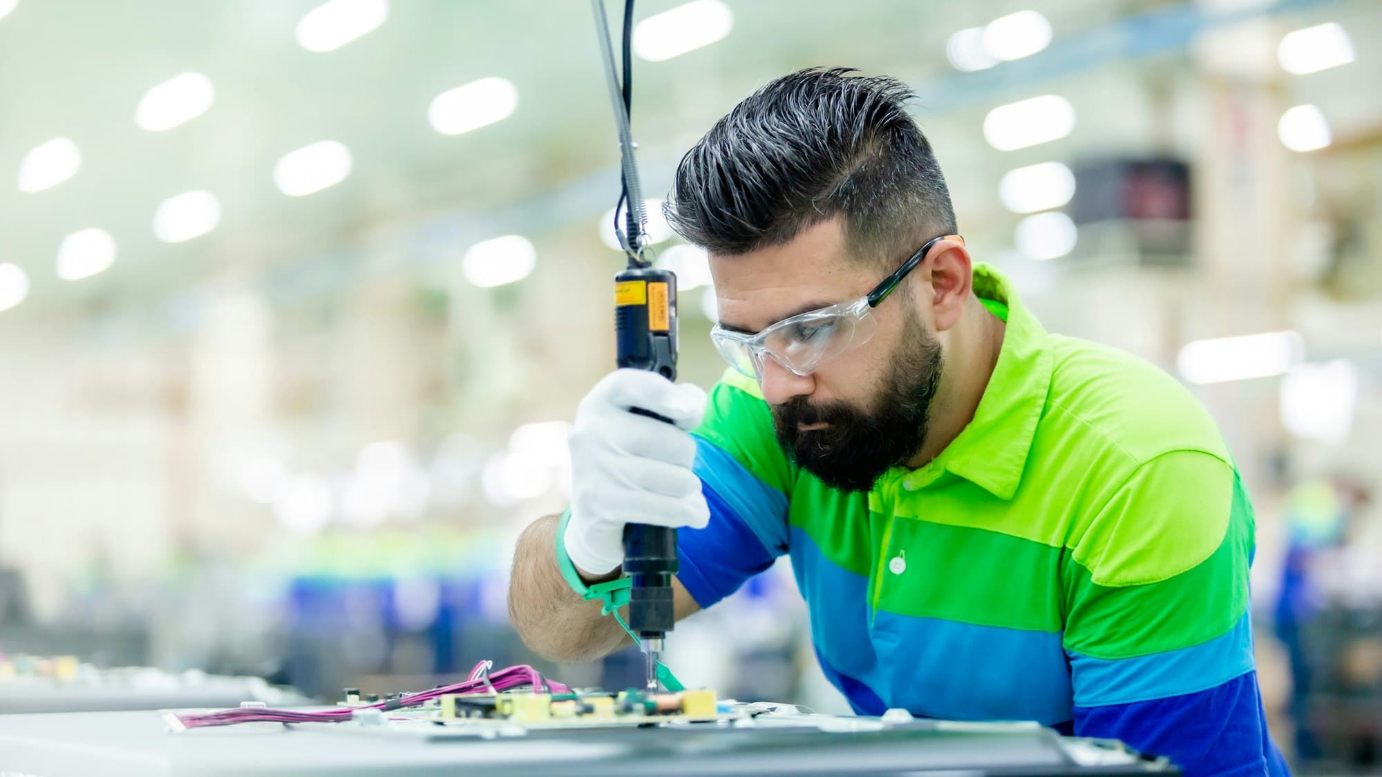 An engineer working on a piece of equipment in a factory